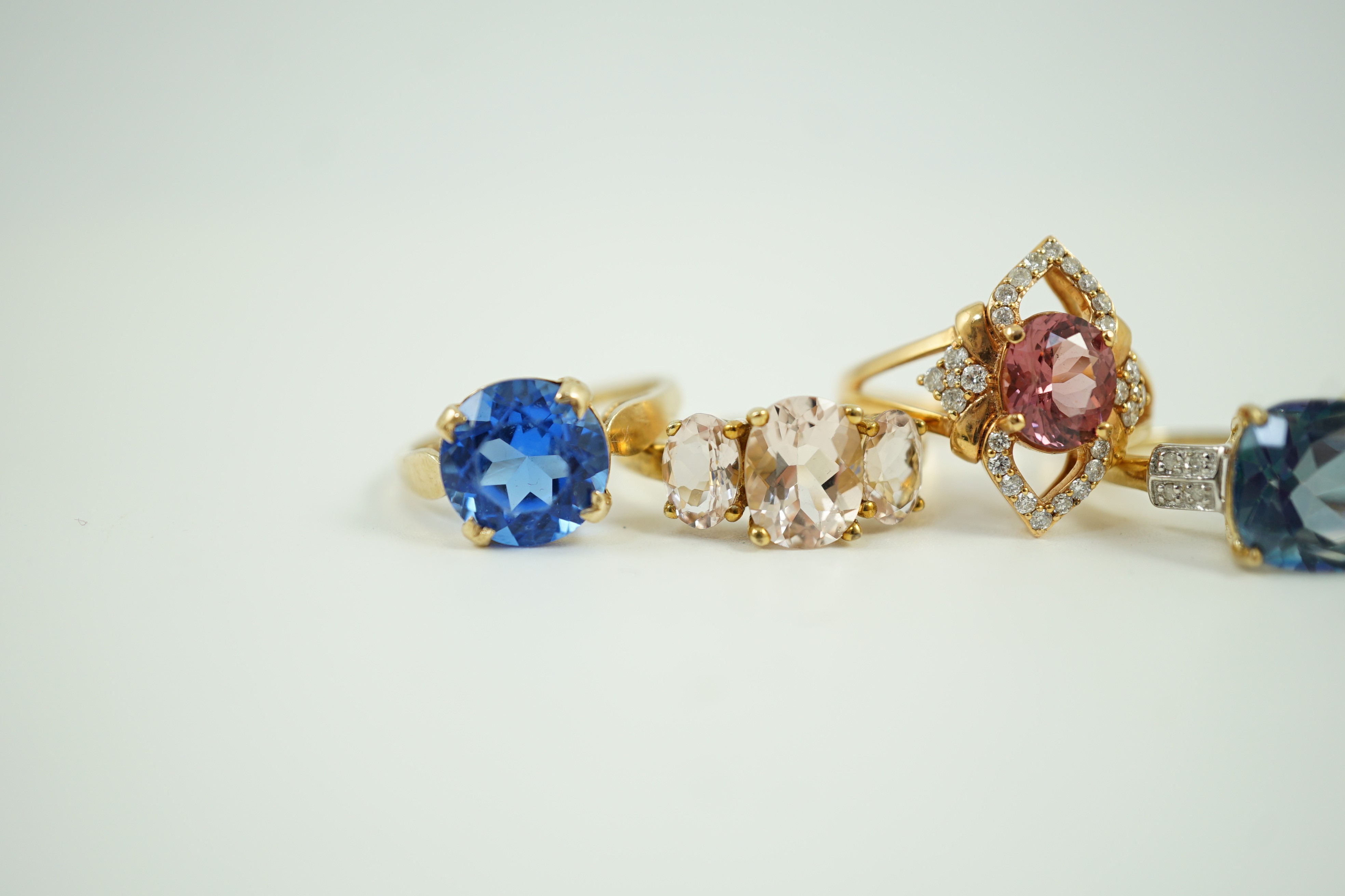 Four assorted modern 9ct gold and gem set rings and a similar 9k gem set ring, gross weight 16 grams.